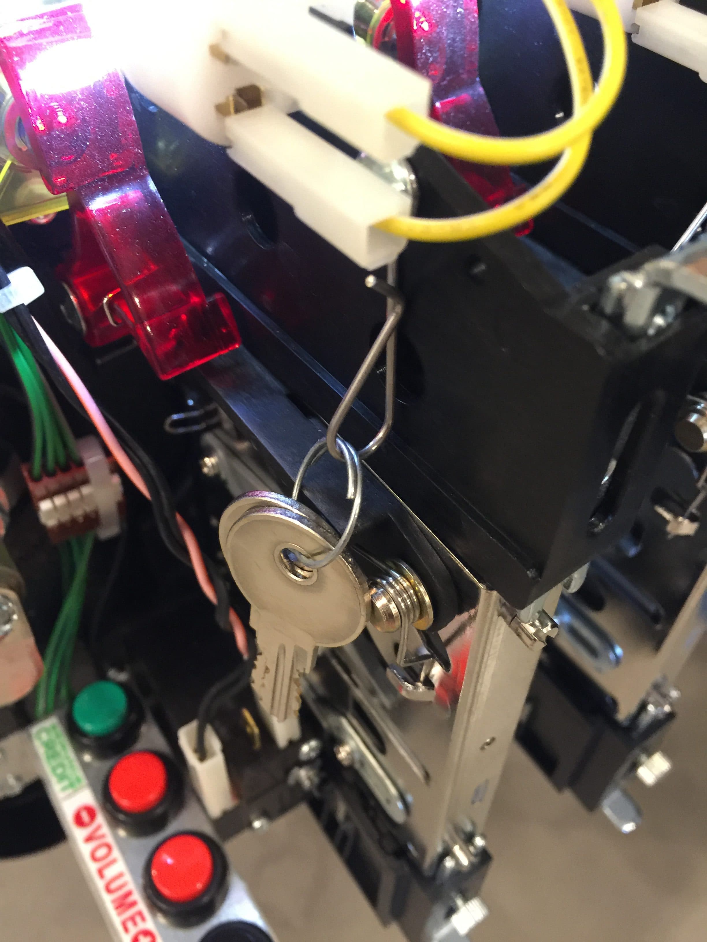 Close-up of machine control panel with key, buttons, and colorful wiring