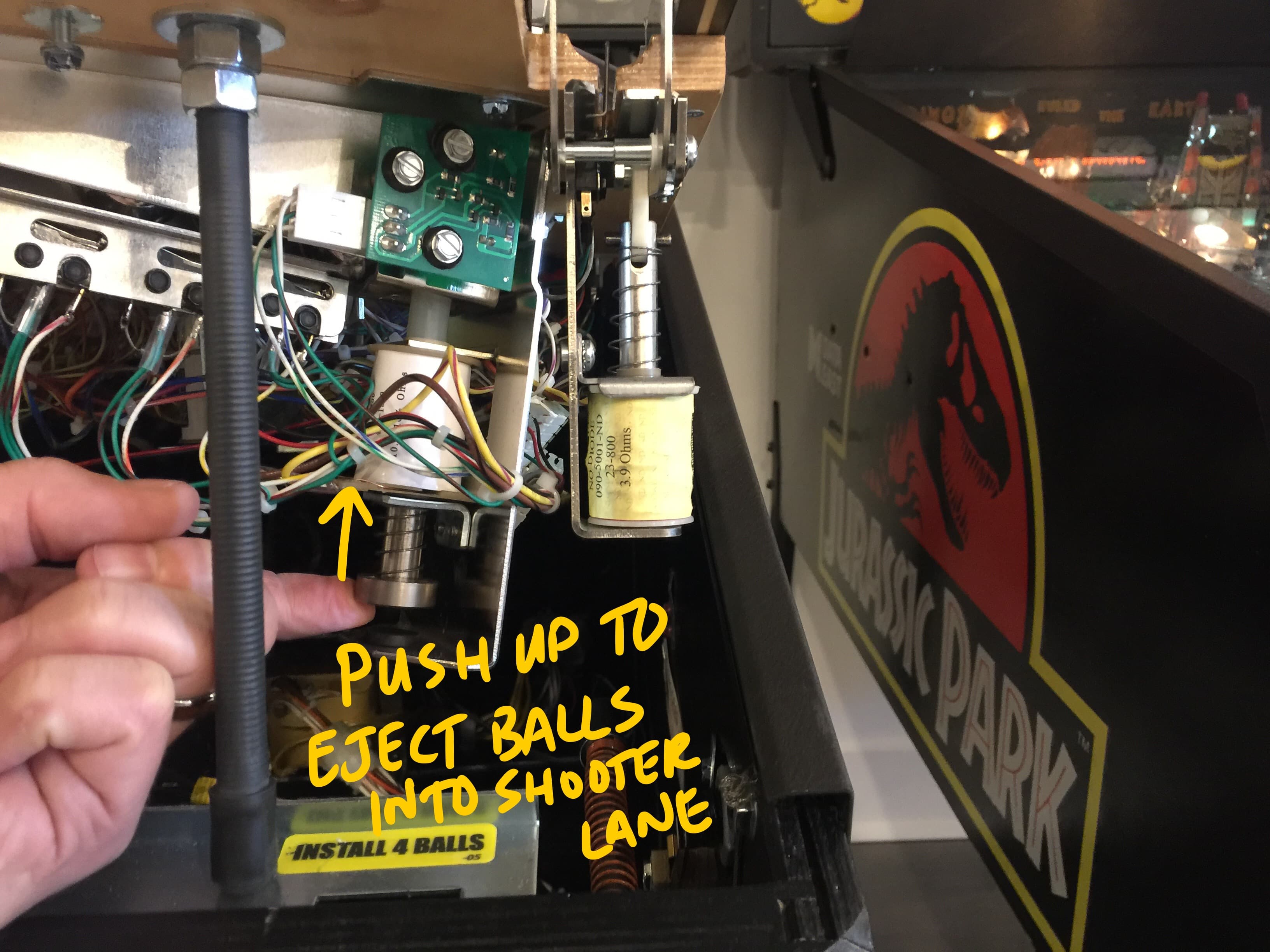 Pinball machine internal mechanism with instructions to eject balls