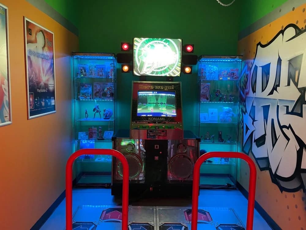 Vintage Konami arcade game machine with blue-lit display shelves