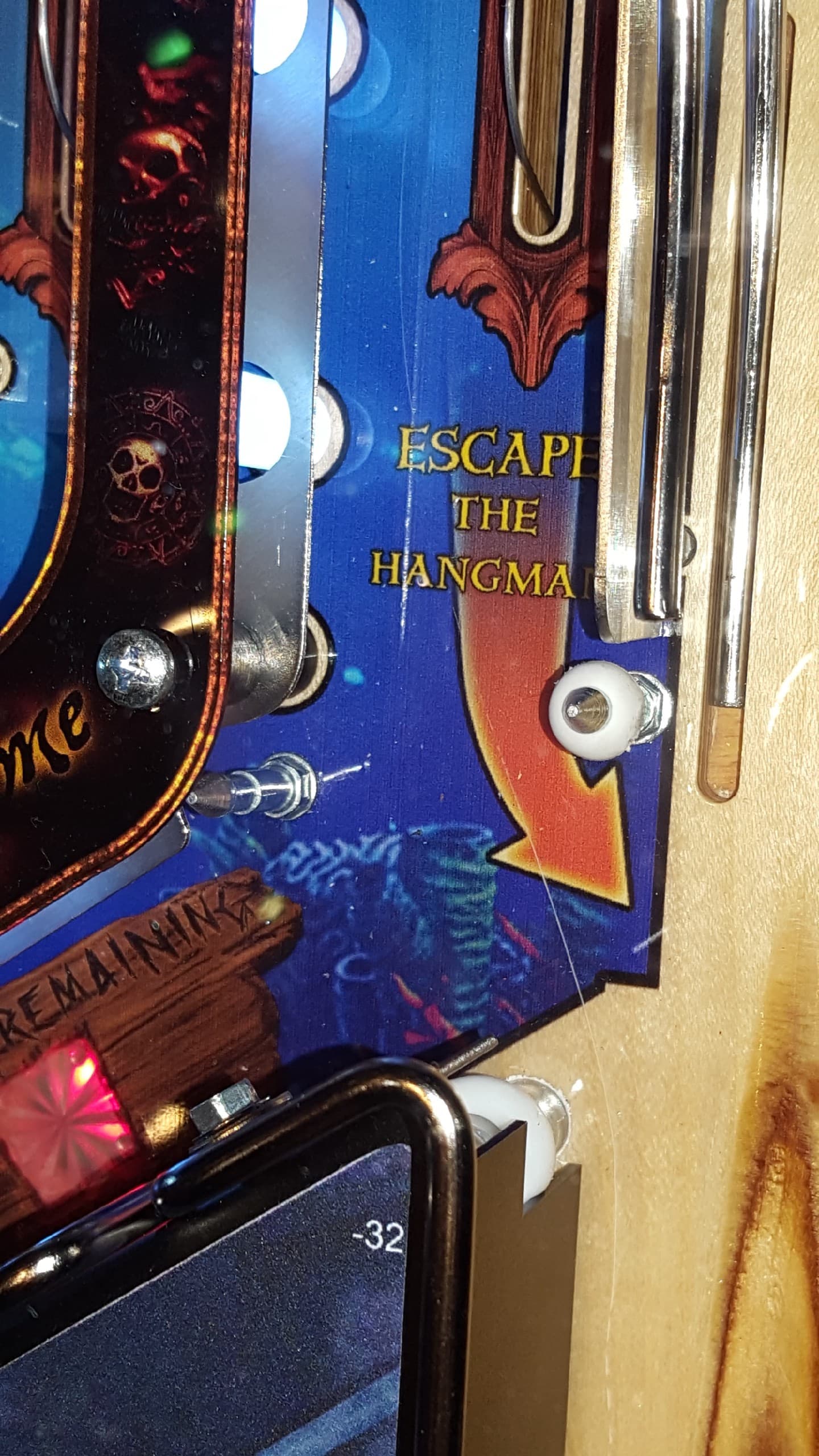 Pinball machine detail with "Escape the Hangman" text and decorative elements