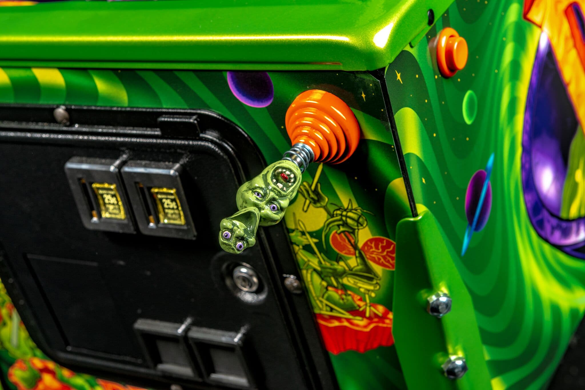 Colorful arcade machine with alien-like creature and vibrant buttons