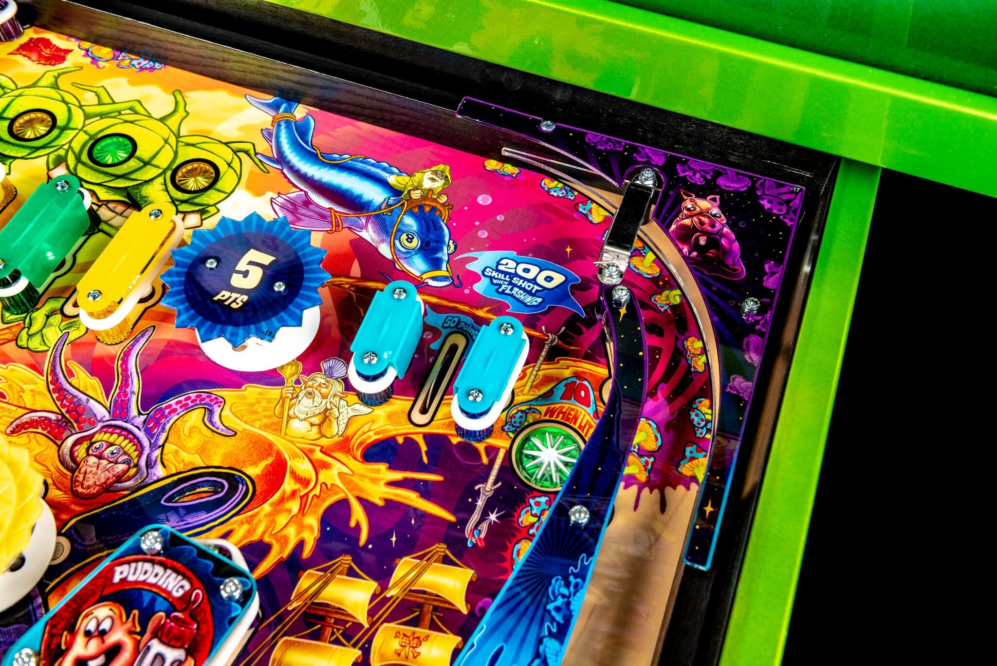 Colorful pinball machine with vibrant cartoon characters and scoring elements