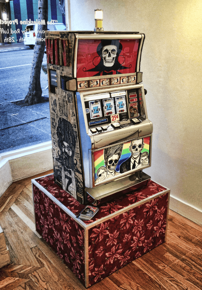 Vintage slot machine with skull graphics on red patterned display stand
