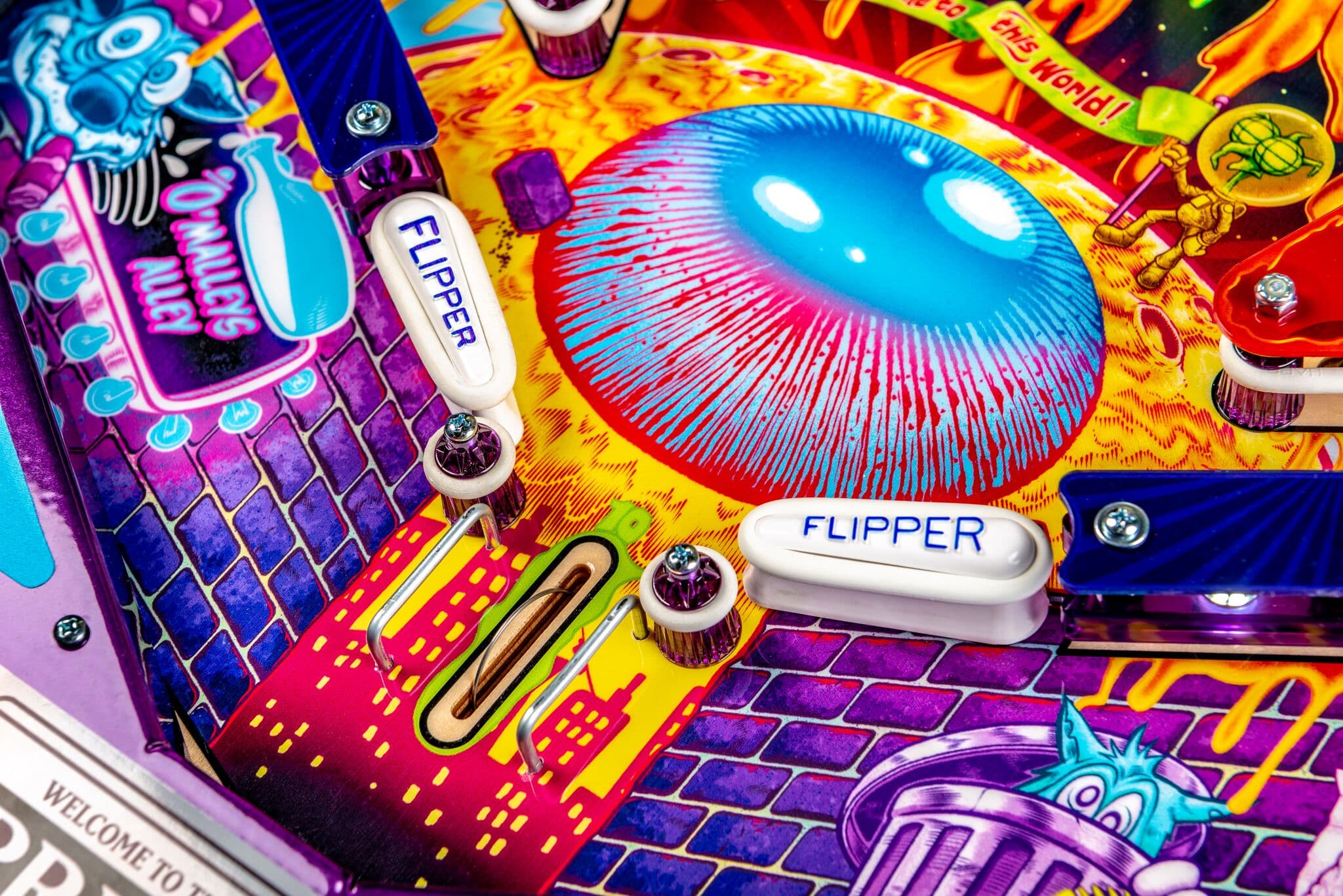 Colorful pinball machine with vibrant blue eye and white flipper buttons