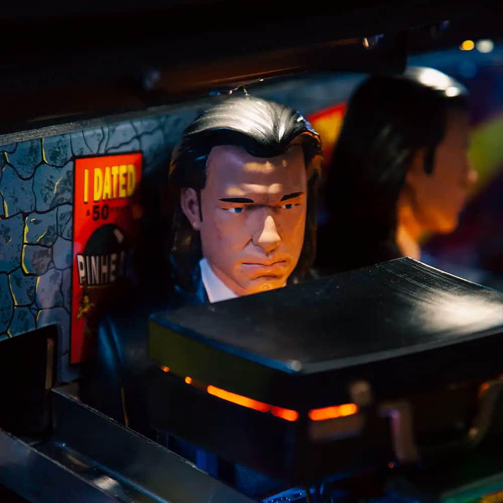 Animated character with slicked-back hair near pinball machine with red sign