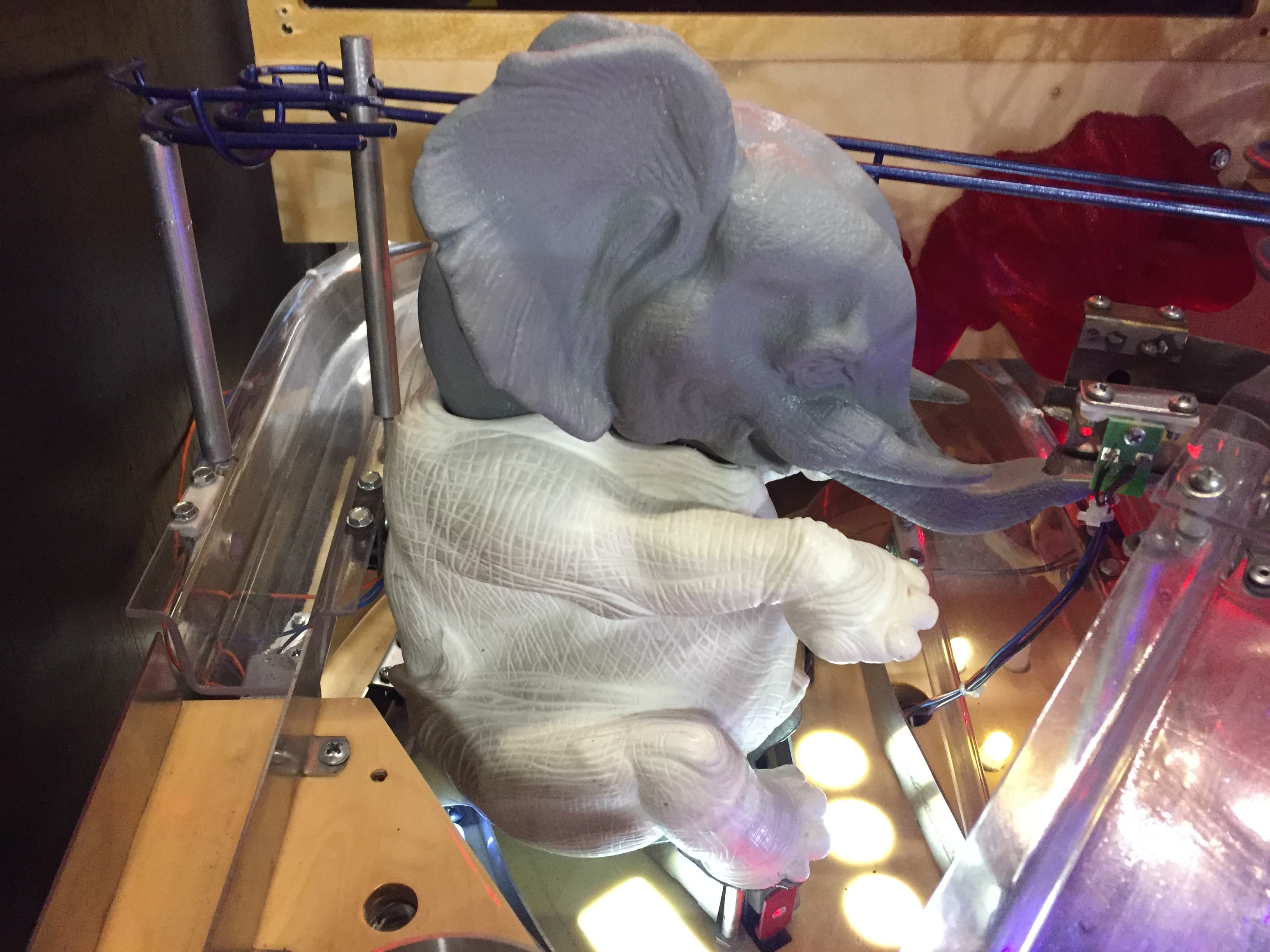 Gray 3D printed elephant figurine on technical equipment