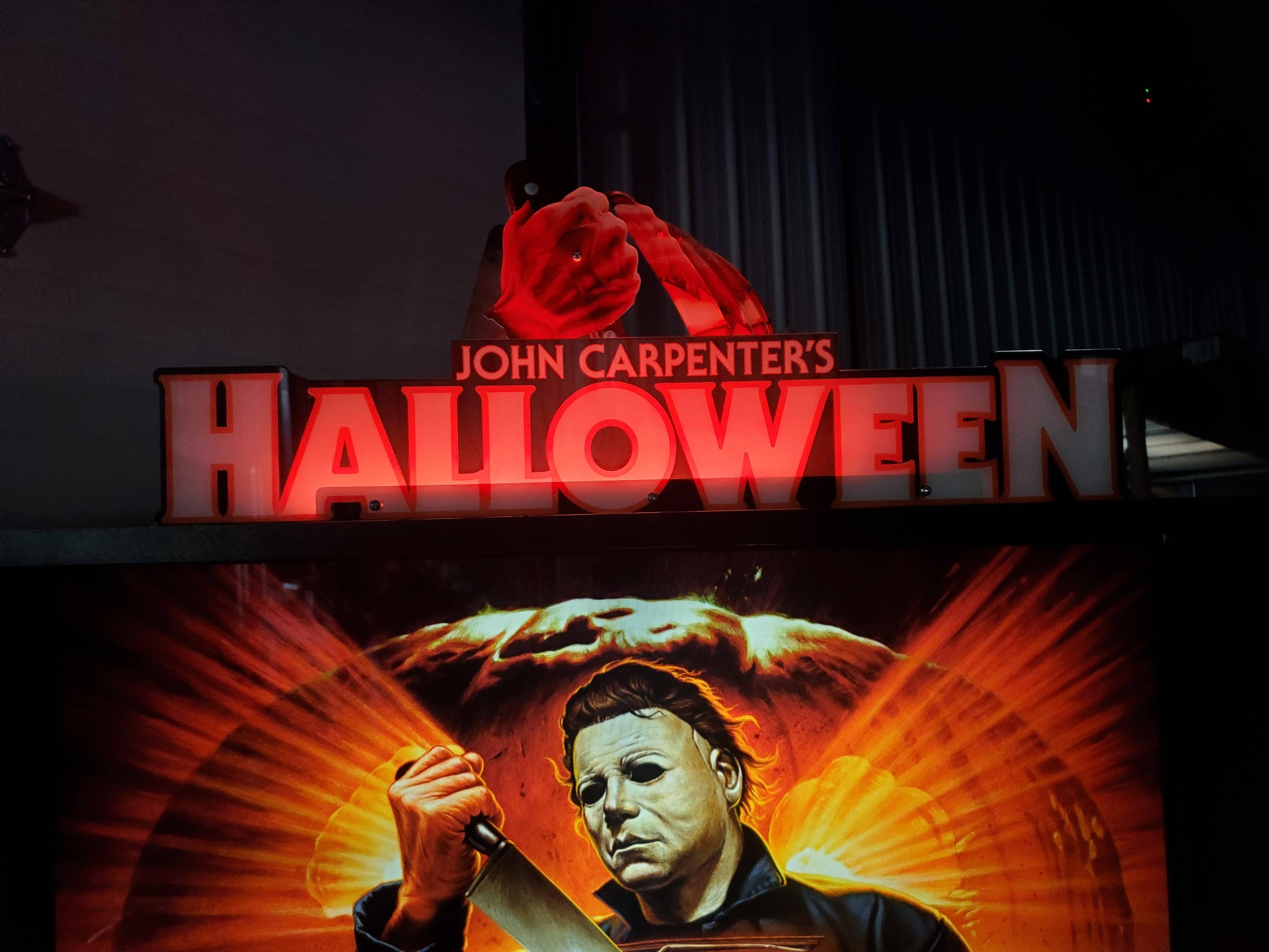 John Carpenter's Halloween movie poster with masked killer and logo