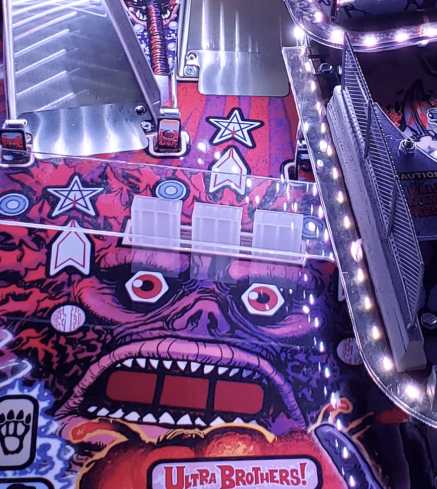 Colorful pinball machine with monster face and Ultra Brothers logo