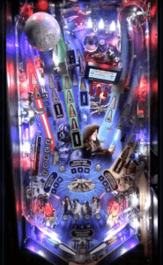 Colorful illuminated pinball machine playfield with intricate electronic components