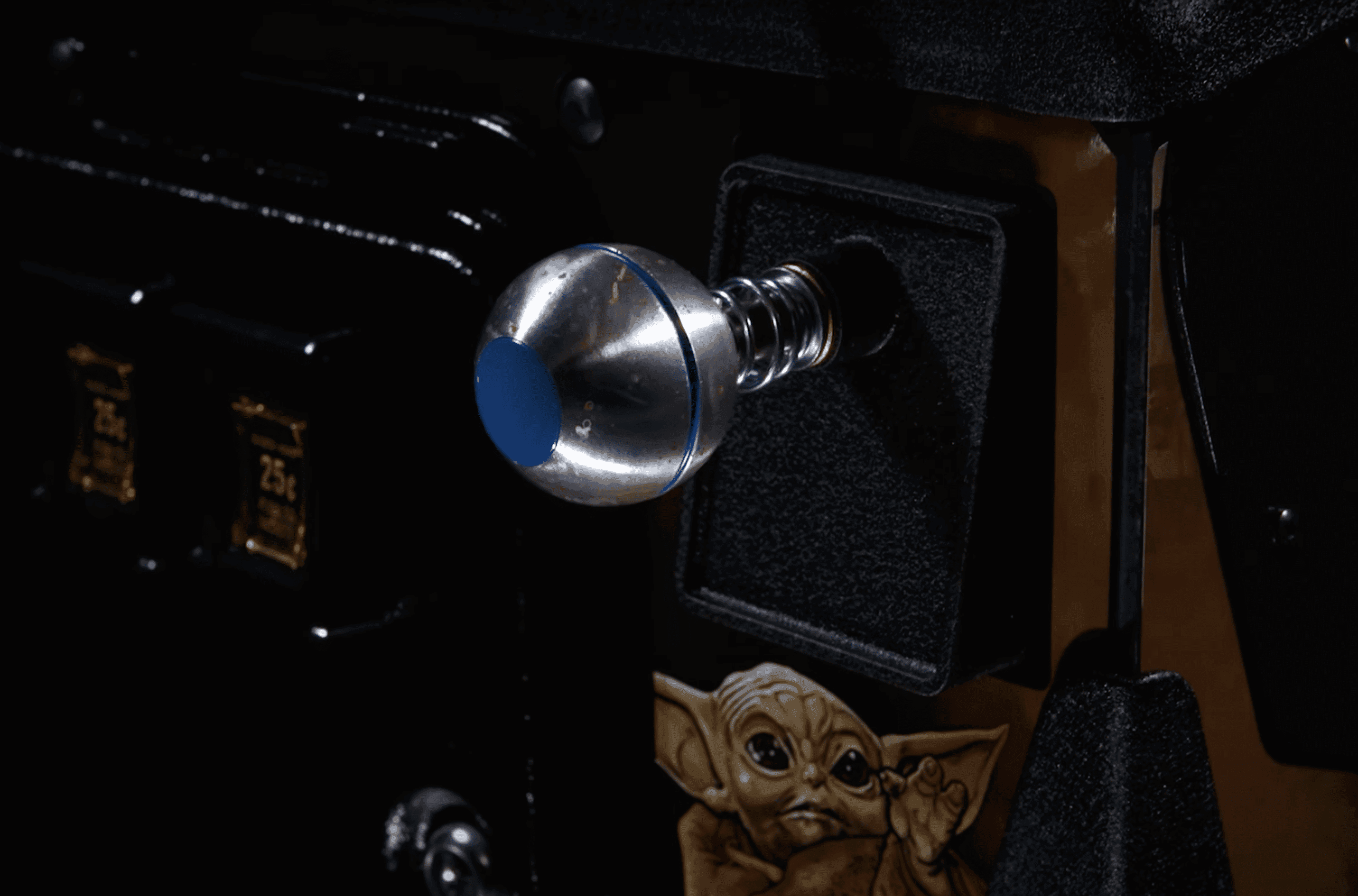 Metallic light bulb and small alien figurine in dark, dramatic setting