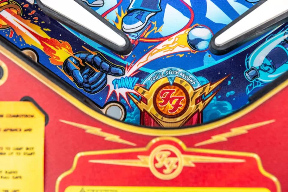 Colorful pinball machine artwork with Foo Fighters logo and explosive graphics