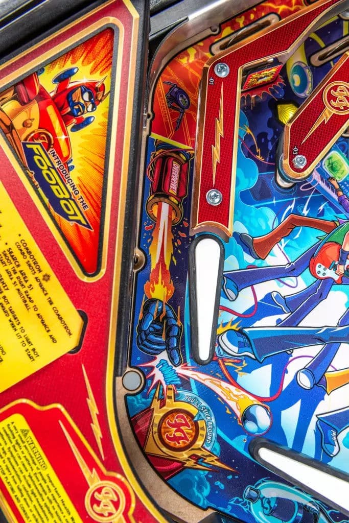 Colorful vintage pinball machine with superhero-style graphic design