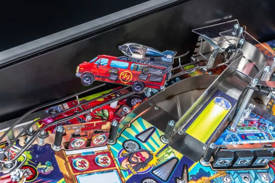 Colorful pinball machine closeup with red fire truck and detailed artwork