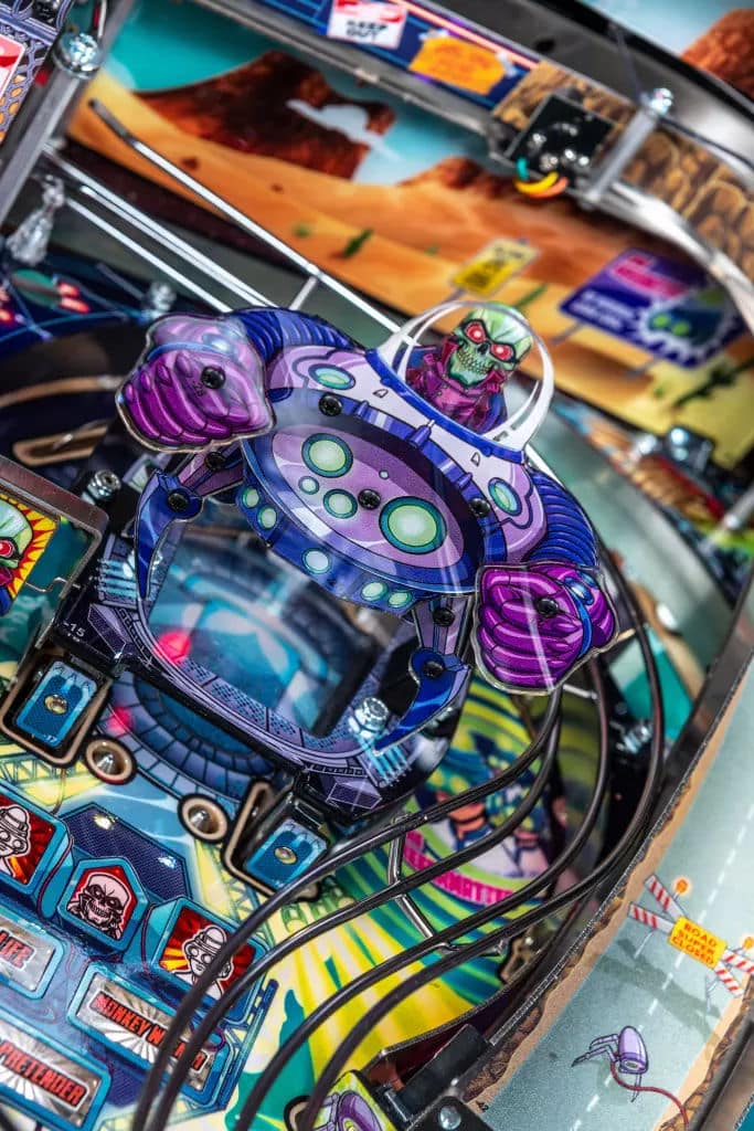 Colorful alien spaceship on vibrant pinball machine playfield