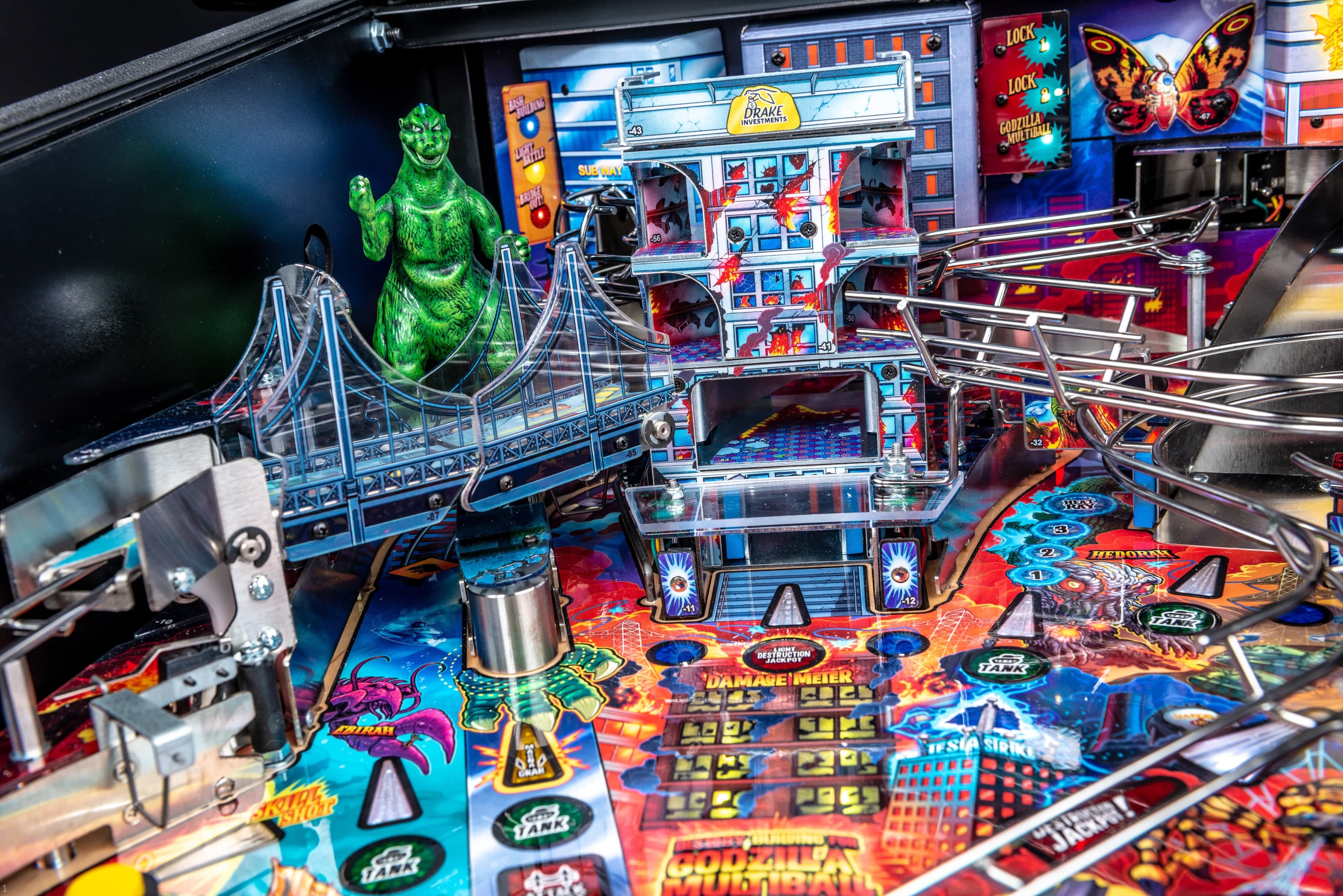 Godzilla-themed pinball machine with colorful monsters and city landscape