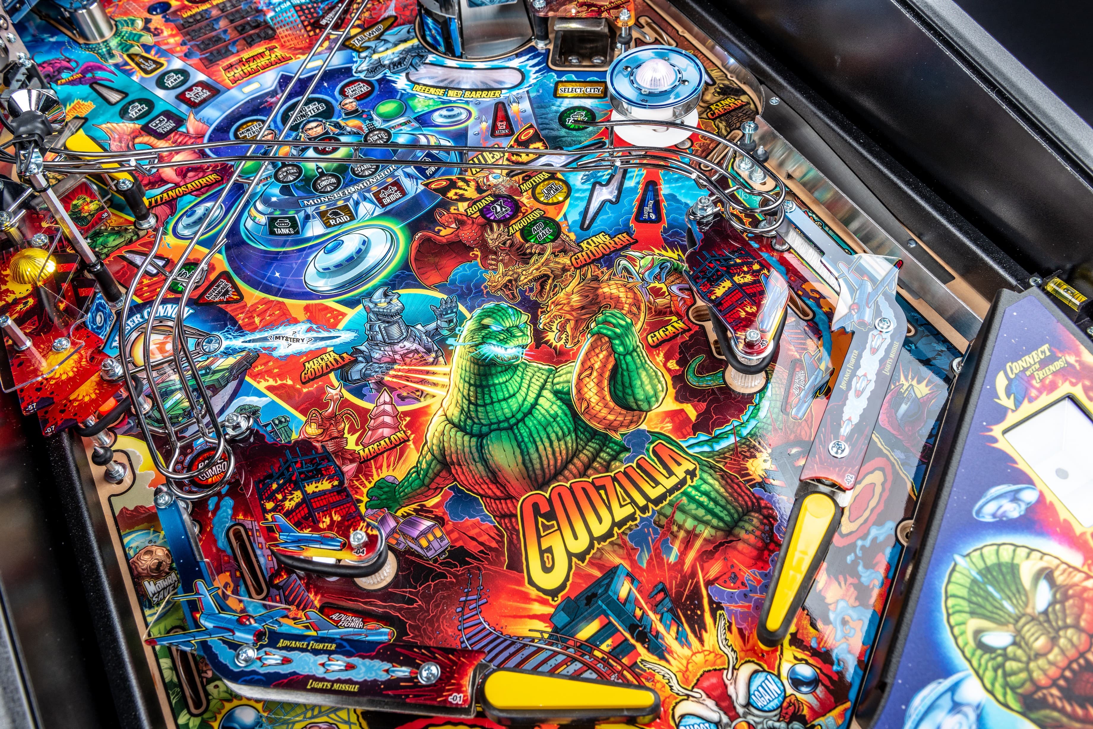 Colorful Godzilla-themed pinball machine with monsters and explosive graphics