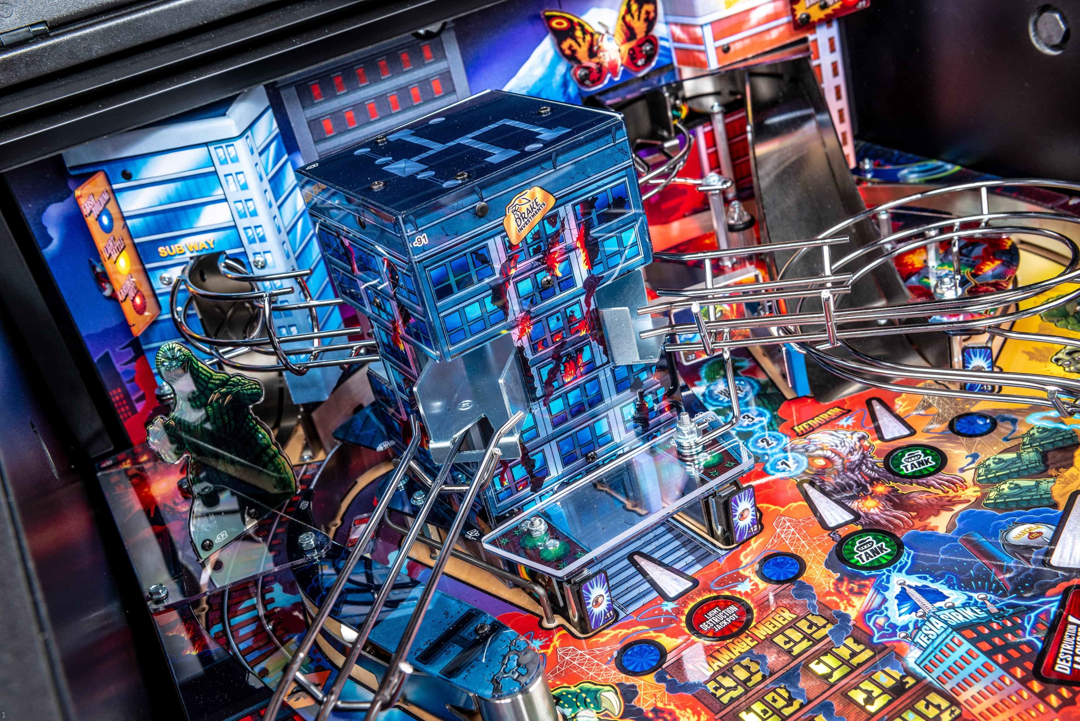 Colorful Godzilla-themed pinball machine with intricate city and monster details
