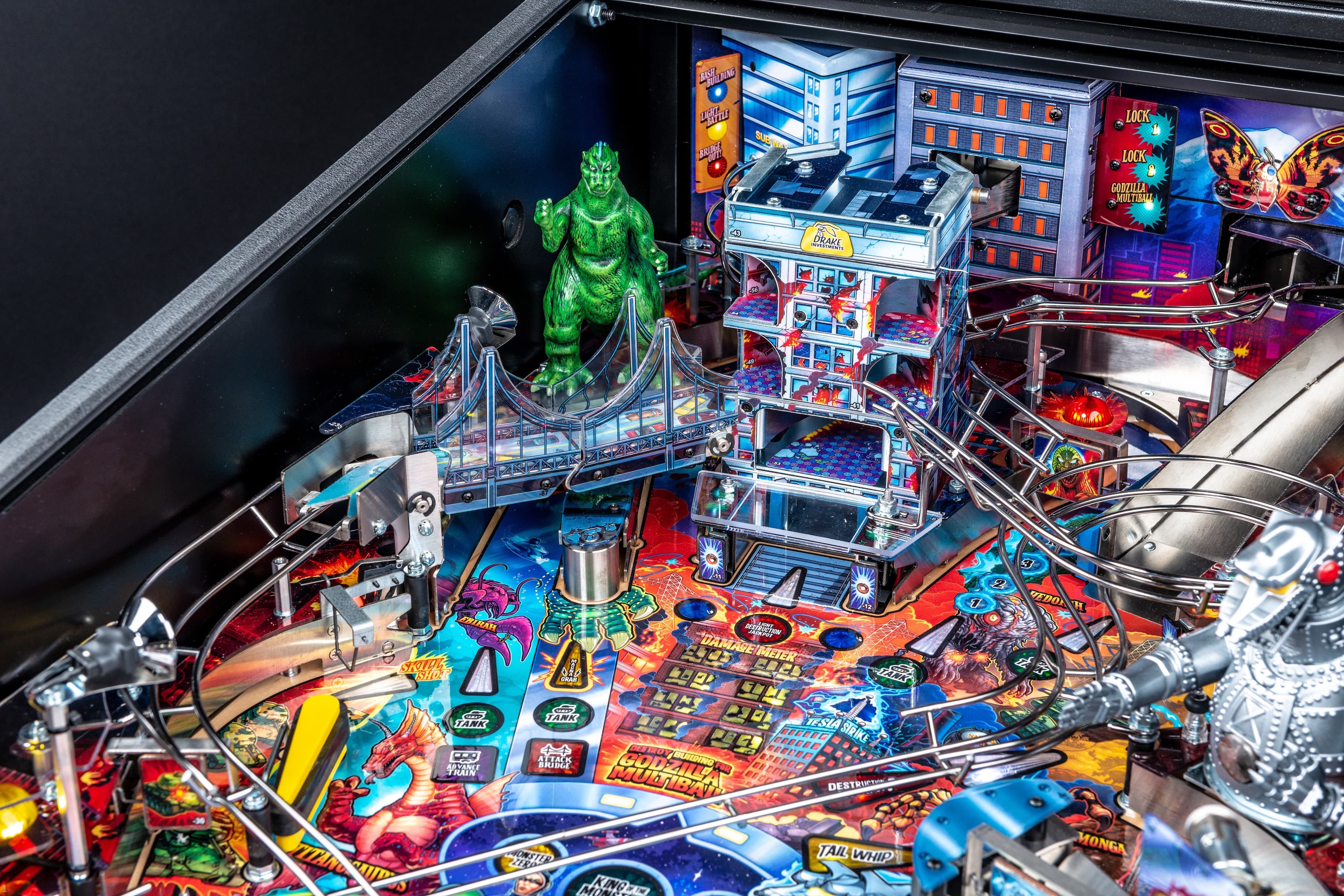 Godzilla-themed pinball machine with colorful cityscape and monster details