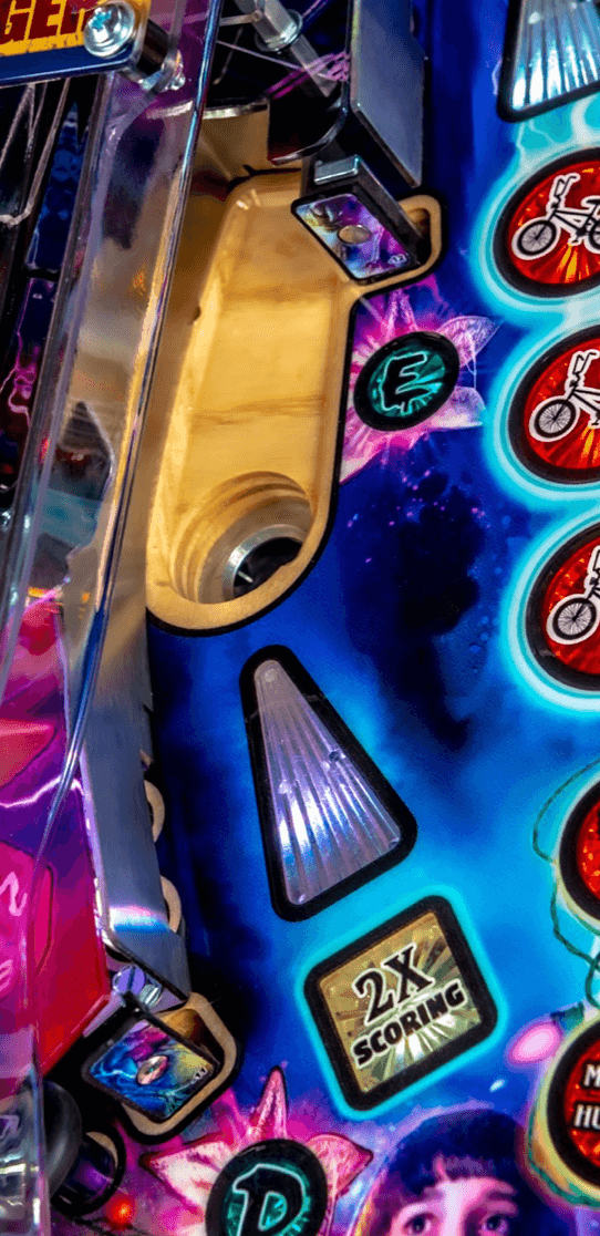 Colorful pinball machine playfield with scoring indicators and vibrant graphics