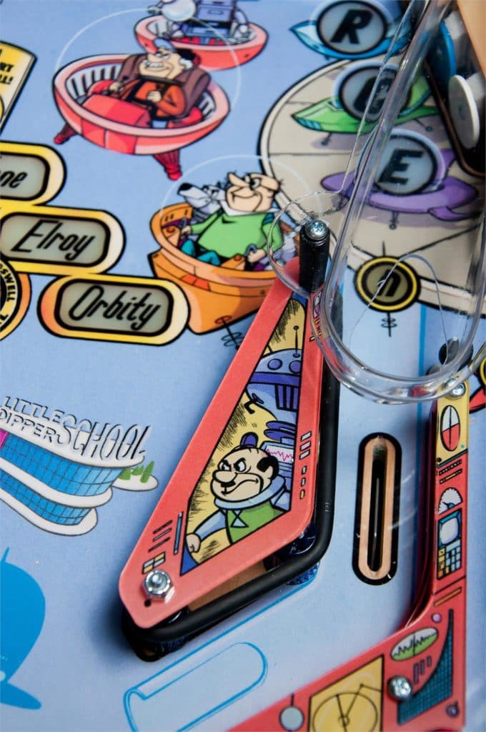 Vintage pinball machine with colorful cartoon characters and playfield details