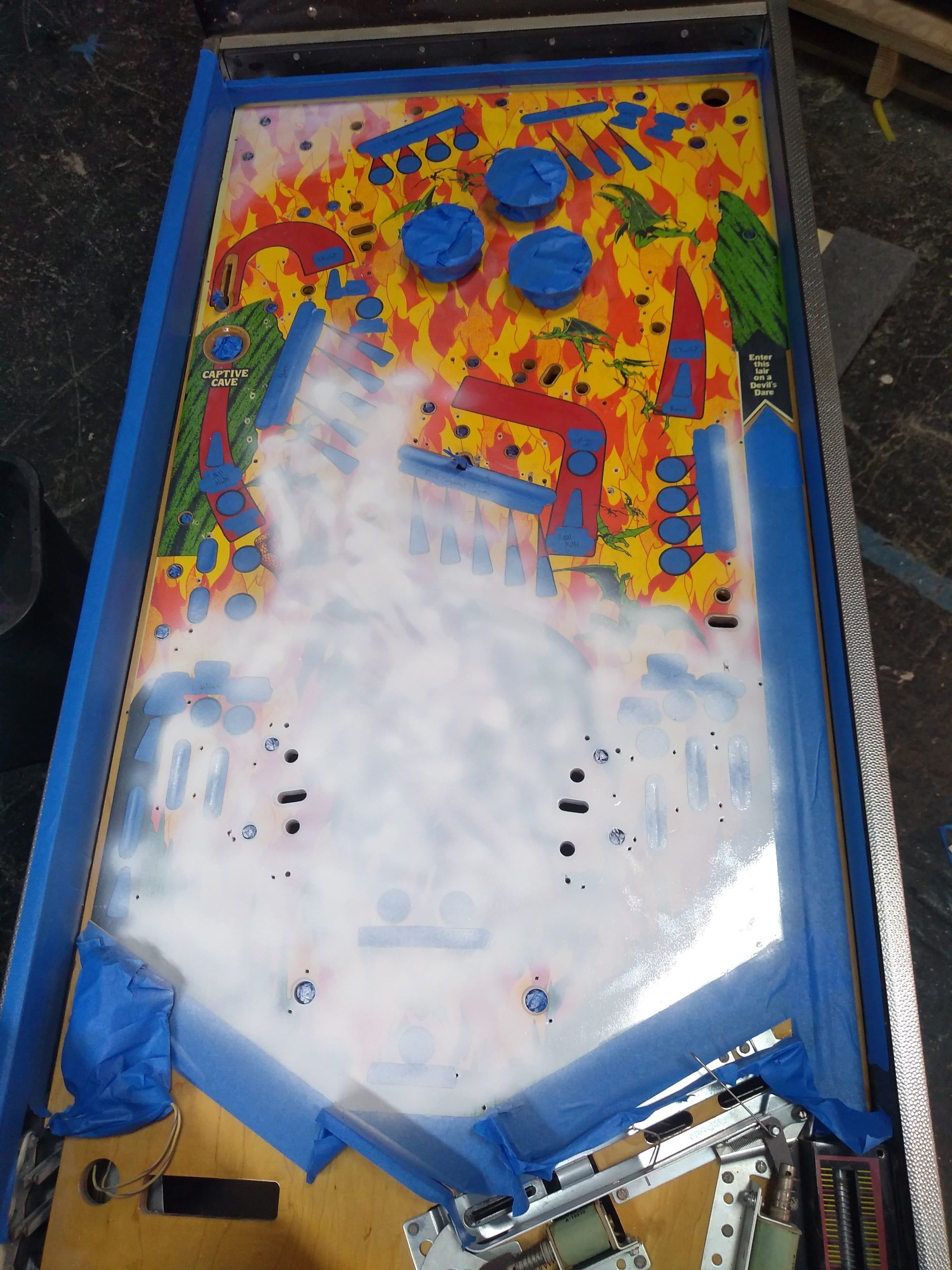 Colorful pinball machine playfield with blue borders and vibrant graphics