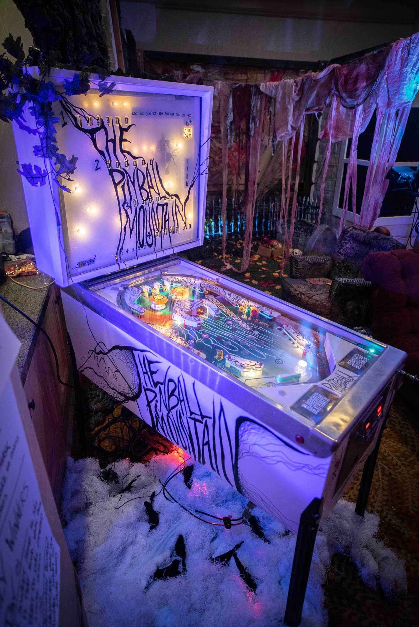 Spooky Halloween-themed pinball machine with eerie blue and purple lighting