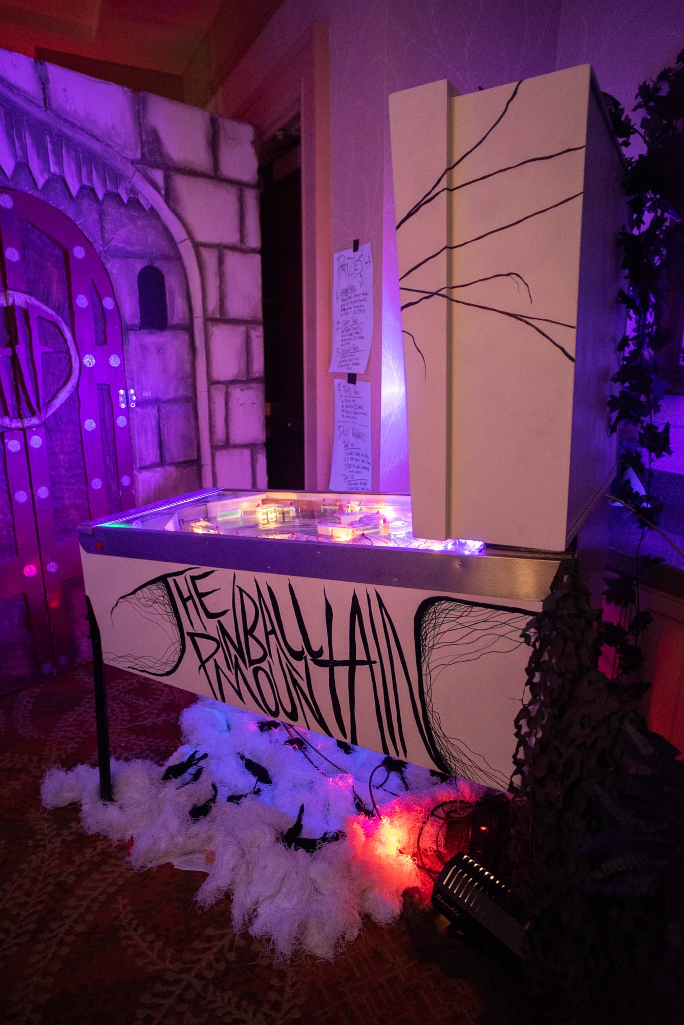 Mysterious pinball machine with purple lighting and gothic castle backdrop