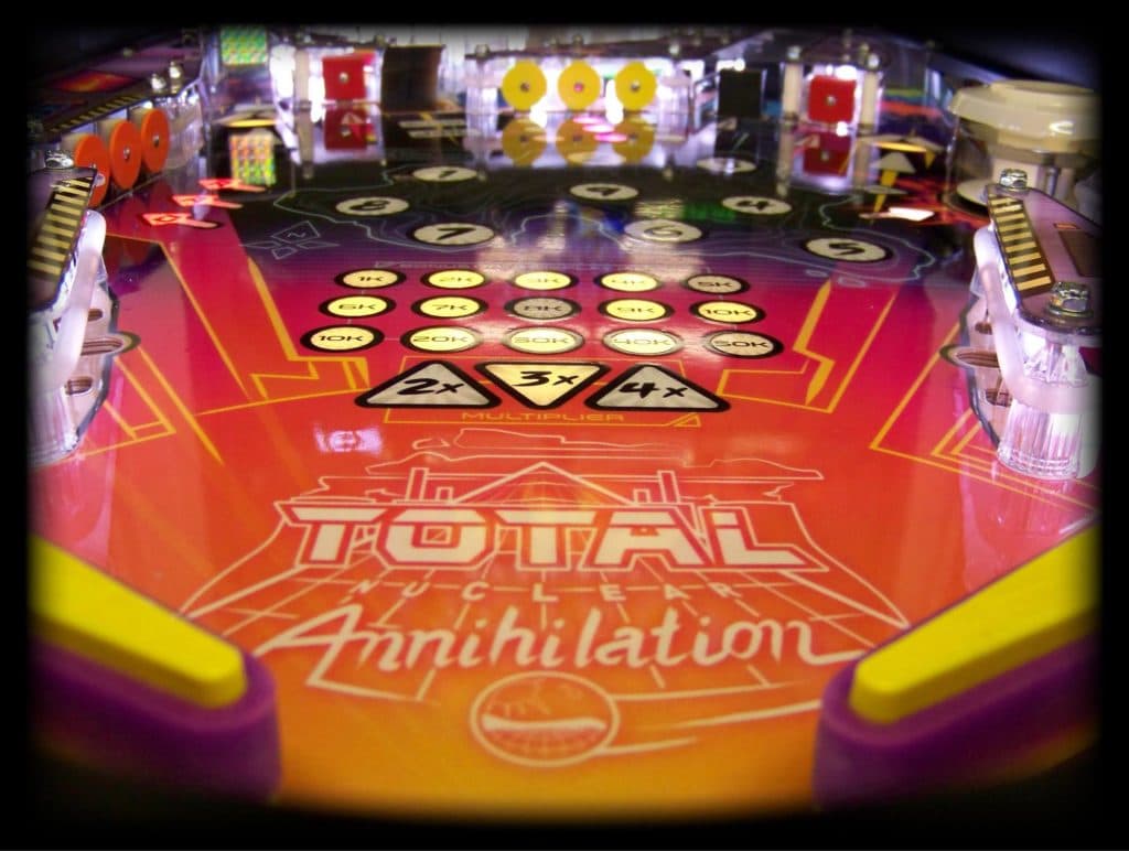 Colorful pinball machine with Total Annihilation theme and scoring board