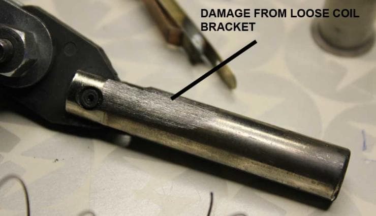 Metal tool with damage from loose coil bracket