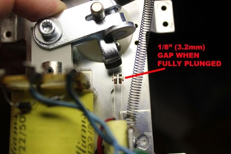 Mechanical component with spring, metal parts, and measurement annotation