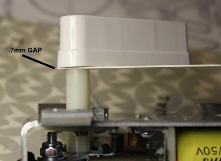 Mechanical component with .7mm gap measurement marked on white surface