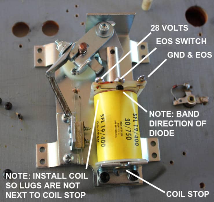Technical diagram of electrical component with yellow capacitor and metal mounting