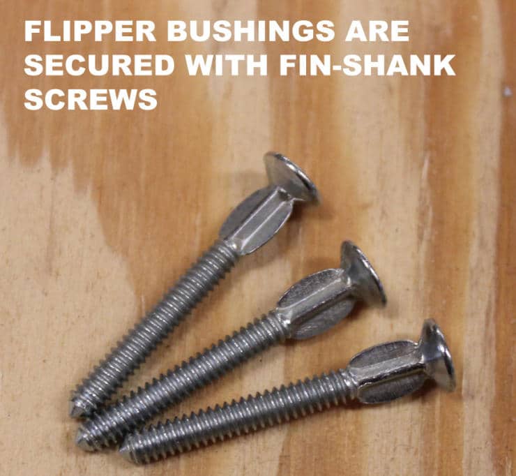Three fin-shank screws used for securing flipper bushings on wooden surface