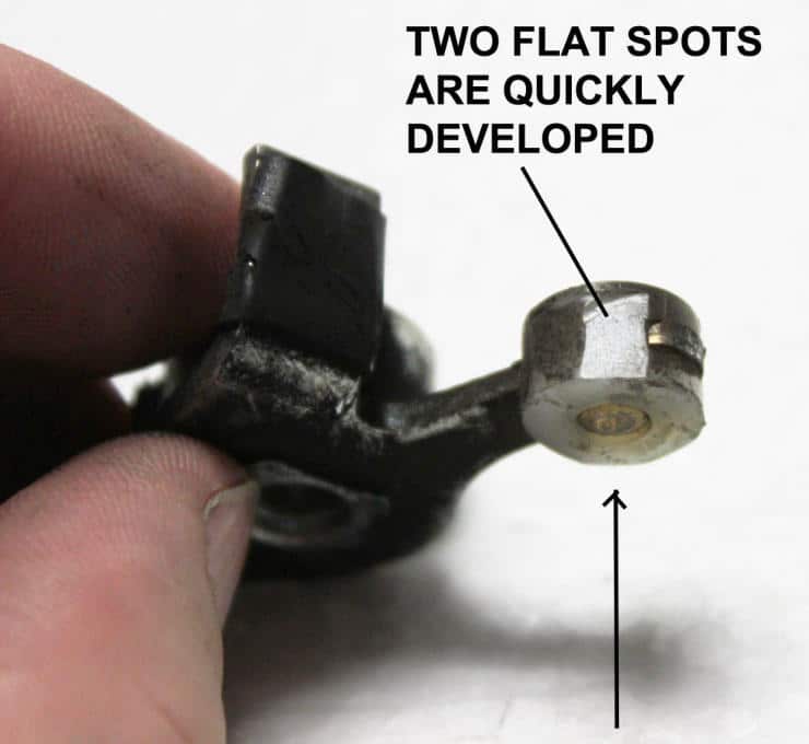 Damaged metal component with two flat spots on a worn mechanical part