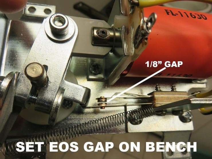 Mechanical setup showing 1/8" gap adjustment on an EOS machine bench