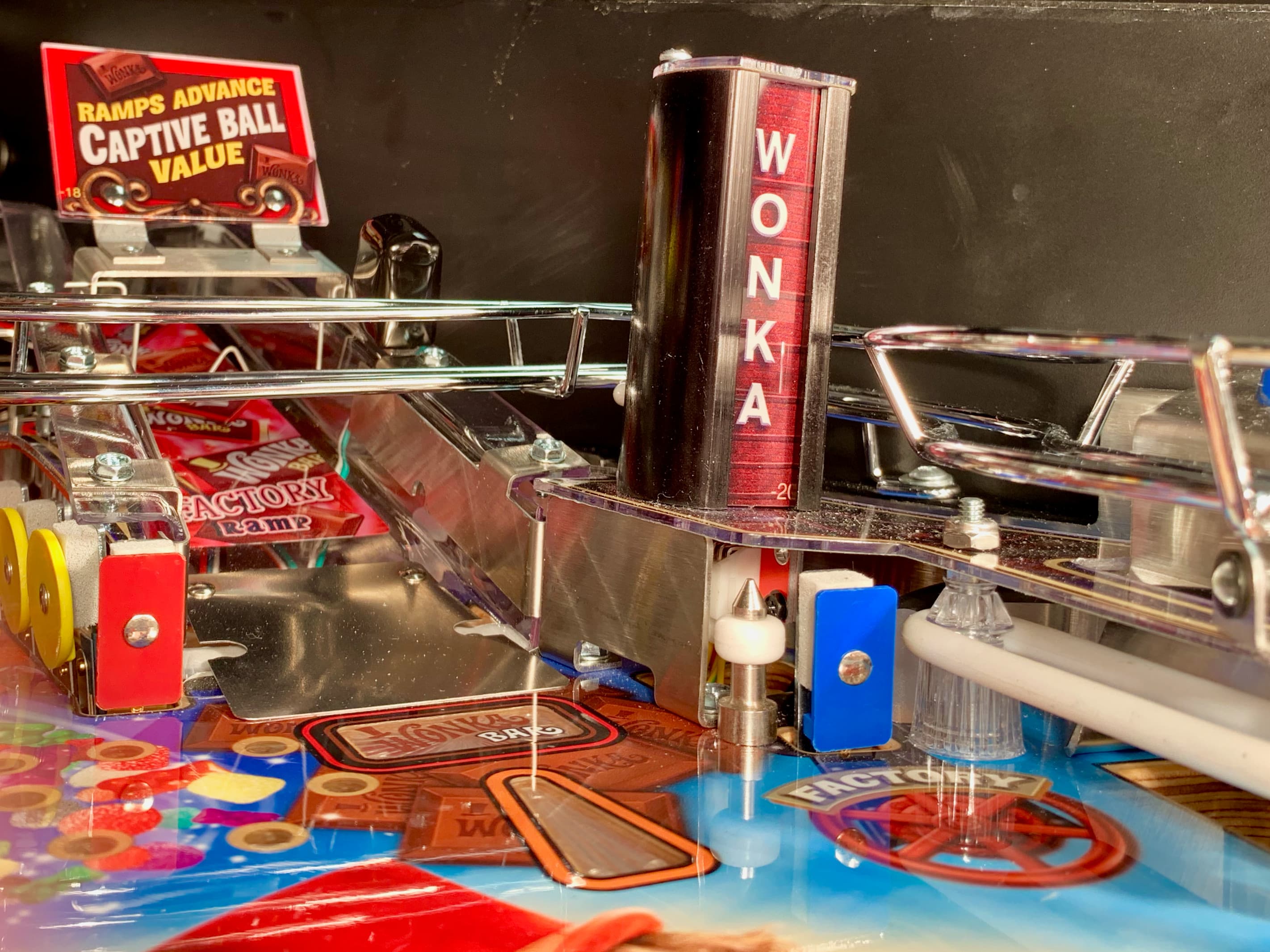 Detailed view of a Wonka pinball machine with colorful playfield components